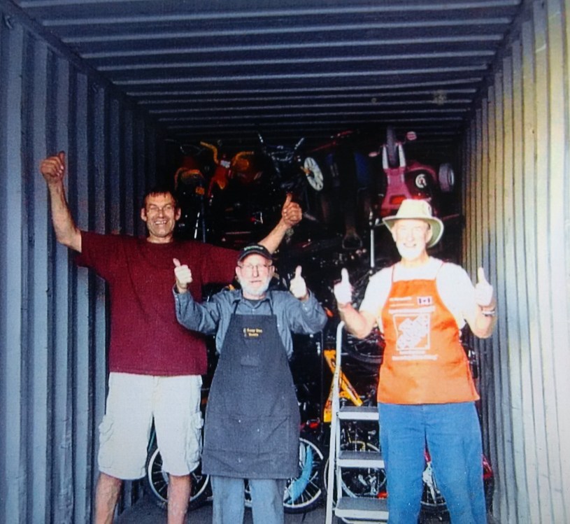 Rolly, a gentleman named Al and myself sharing a laugh as we put the bikes away