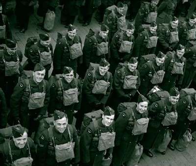 Members of the Canadian Air Force waiting to disembarl at a British port. Who knows what those next few years would be like. Image source.
